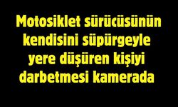 Motosiklet sürücüsünün kendisini süpürgeyle yere düşüren kişiyi darbetmesi kamerada